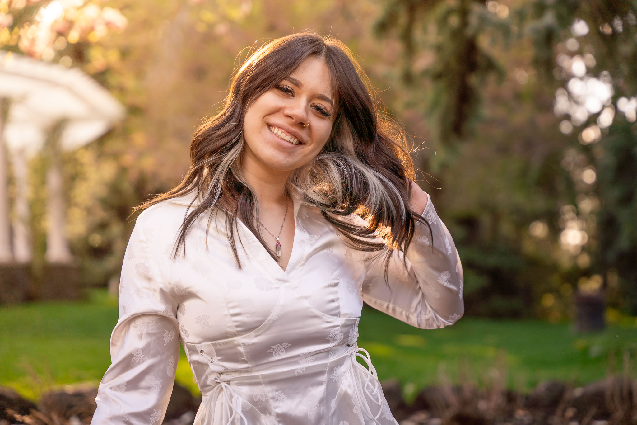  a woman gently playing with her hair while looking into the camera