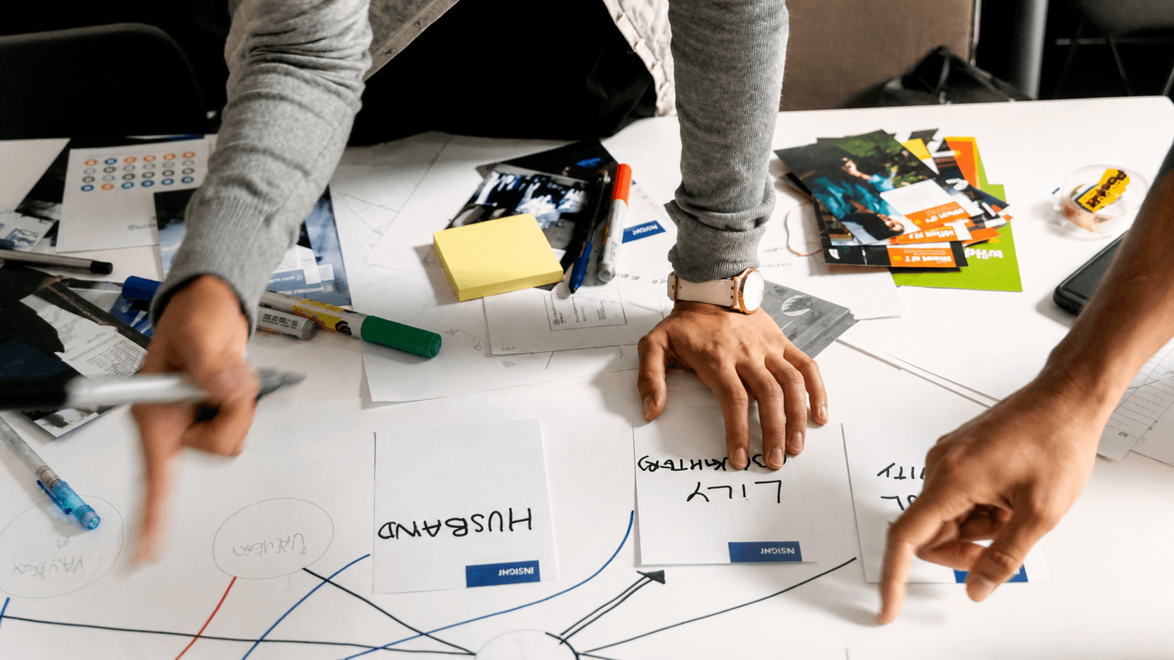 Cross-disciplinary team maps relationships and opportunities during a public health learning lab, using systems thinking and strategic design methods to address complex challenges.