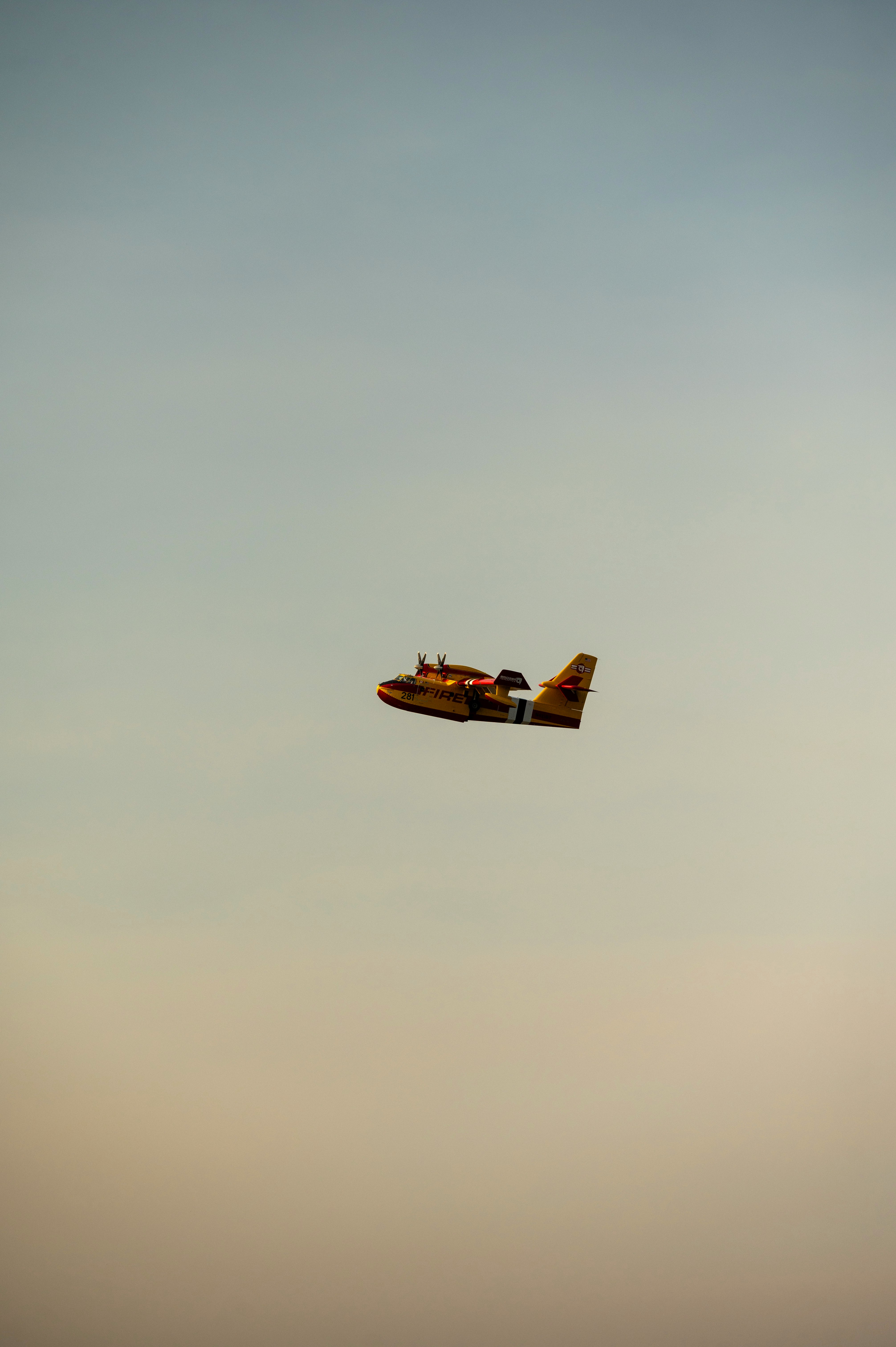 a small airplane flying through a cloudy sky