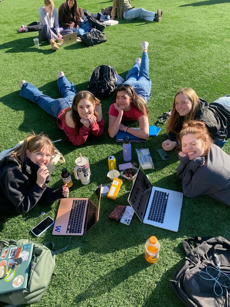 a group of people standing around a park bench