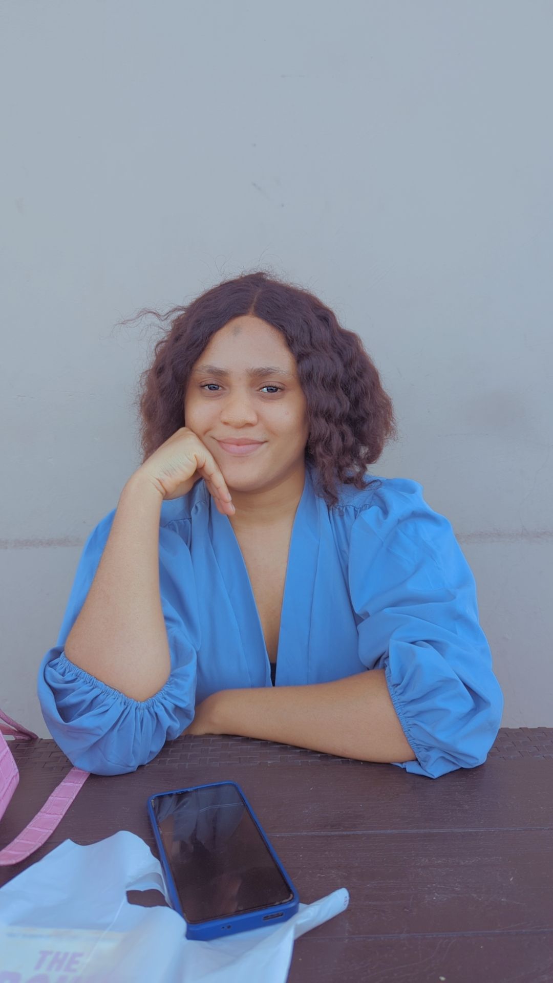 a woman with an afro is looking at the camera