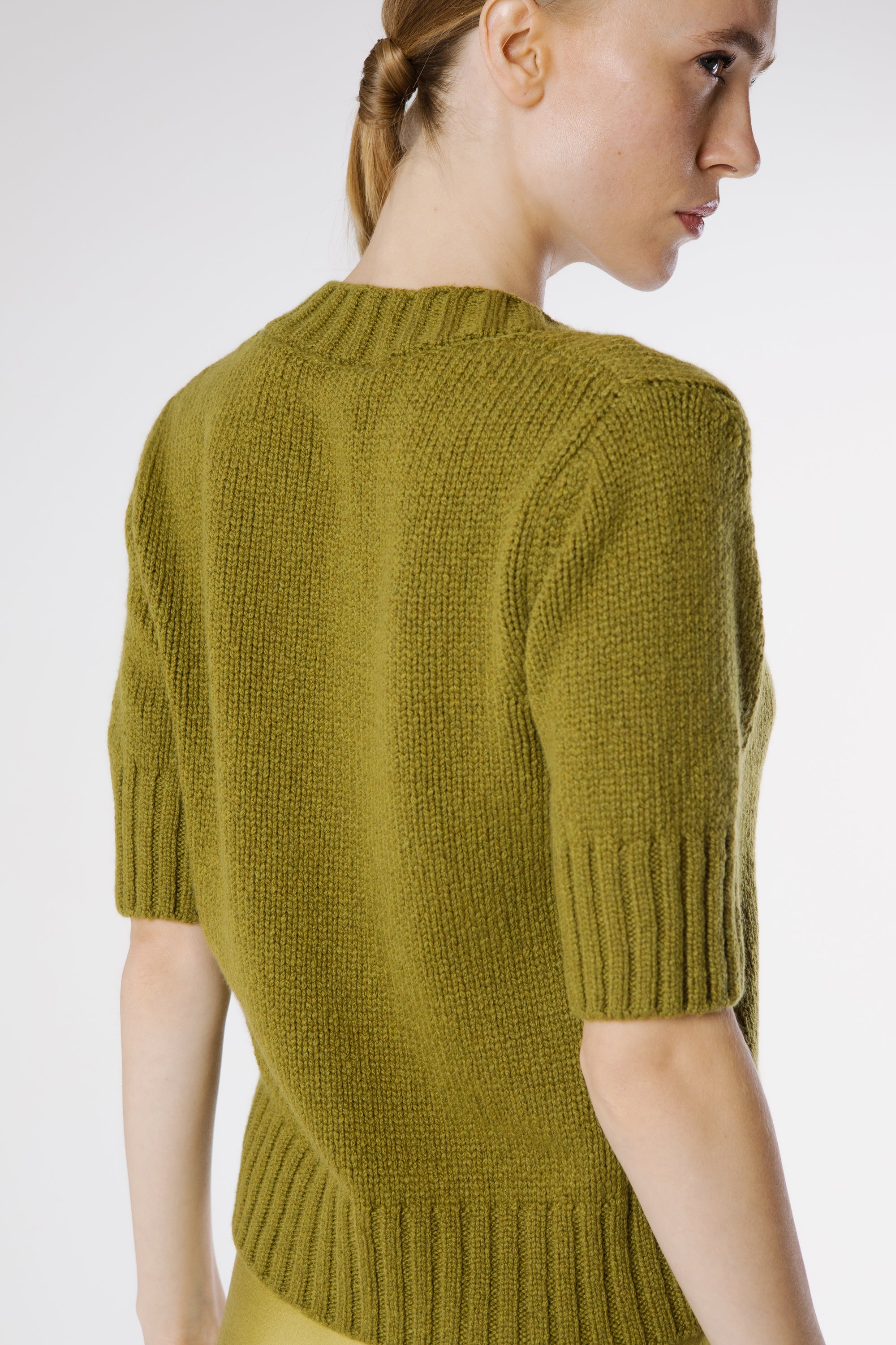 Back view of Artemisa Cashmere Cardigan Juniper showcasing clean silhouette and fine knit structure.