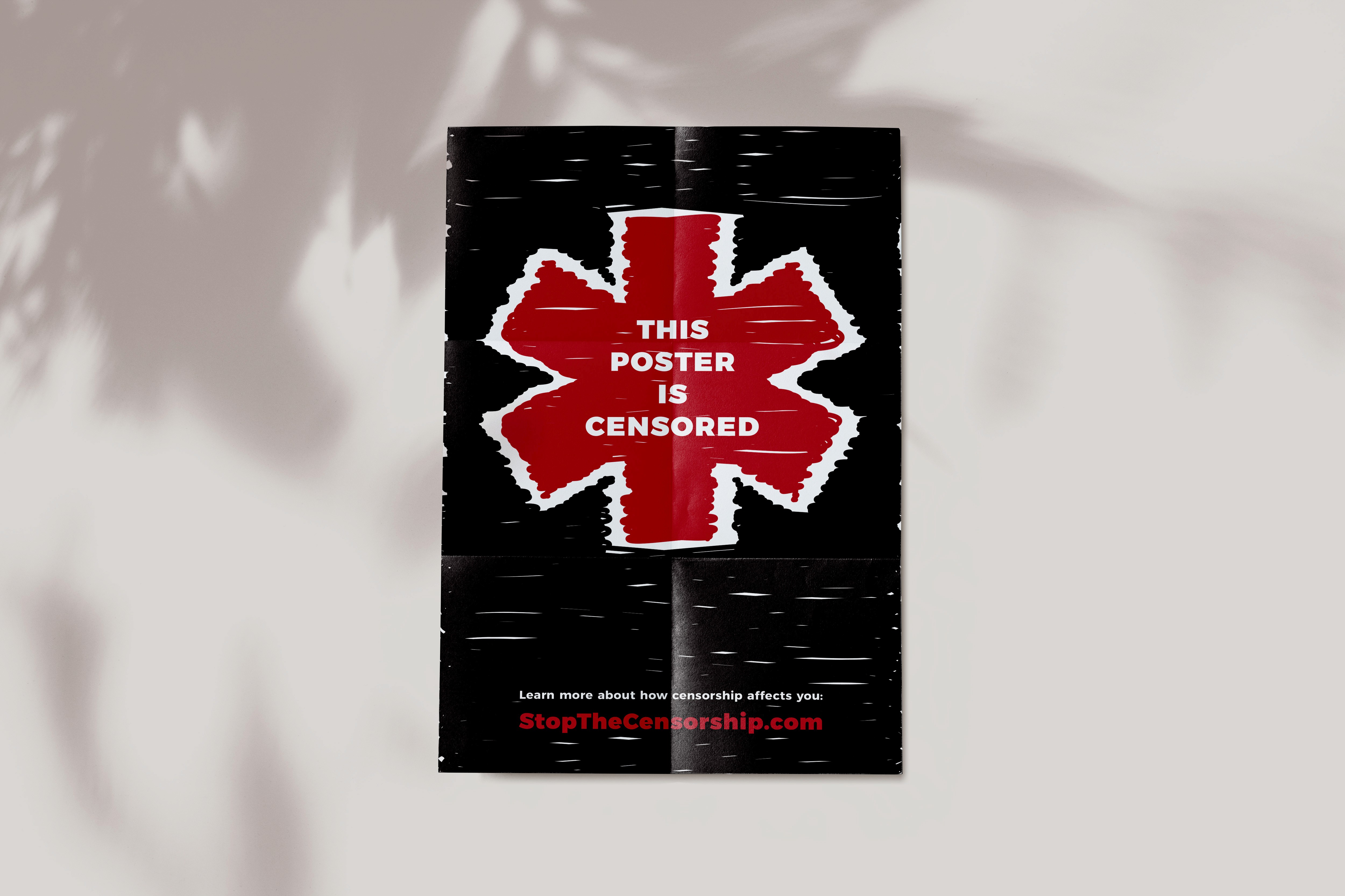An advertisement on a poster saying 'stop the censorship,' on a bright red, scribbled-on asterisk