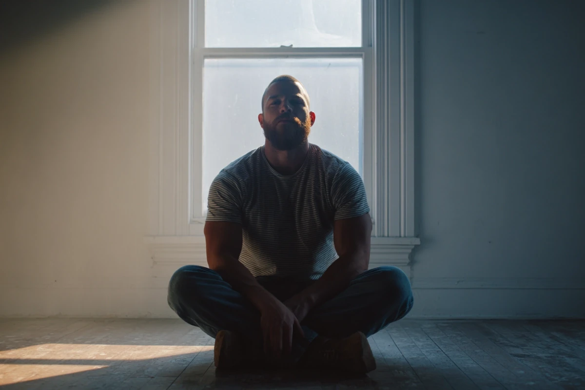 Man sitting in quiet contemplation with steady posture
