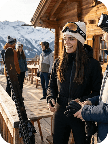Lifestyle scene near a ski lodge, woman chatting outdoors in winter clothing