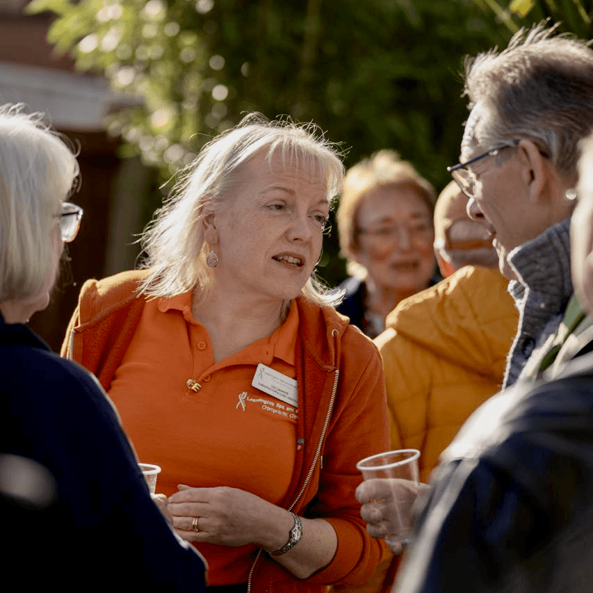 Liz, the founder talking to a group of people at an outdoor event to celebrate LSRC.