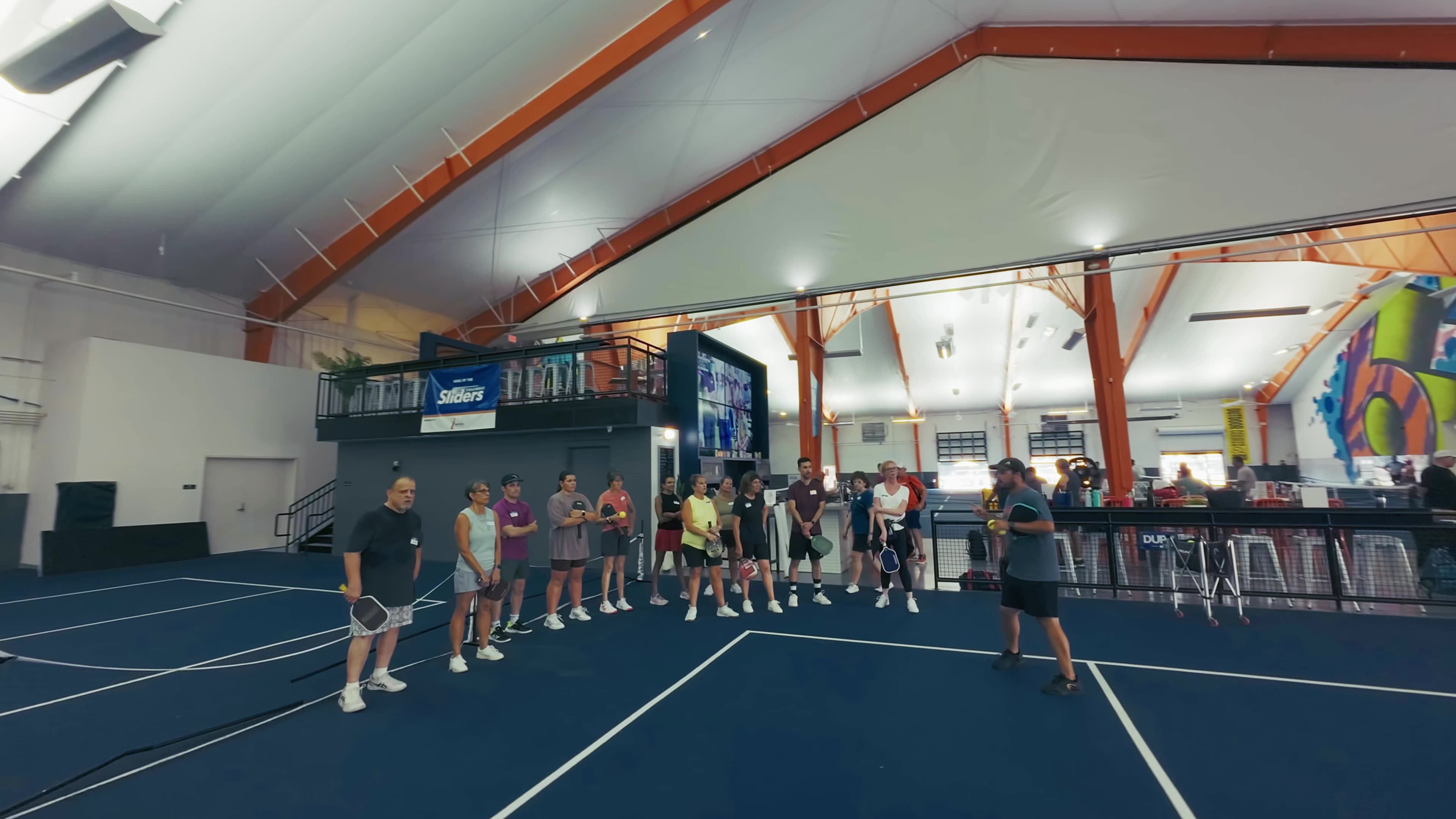 Modern living room with vertical garden, yellow sofas, and stylish coffee tables.