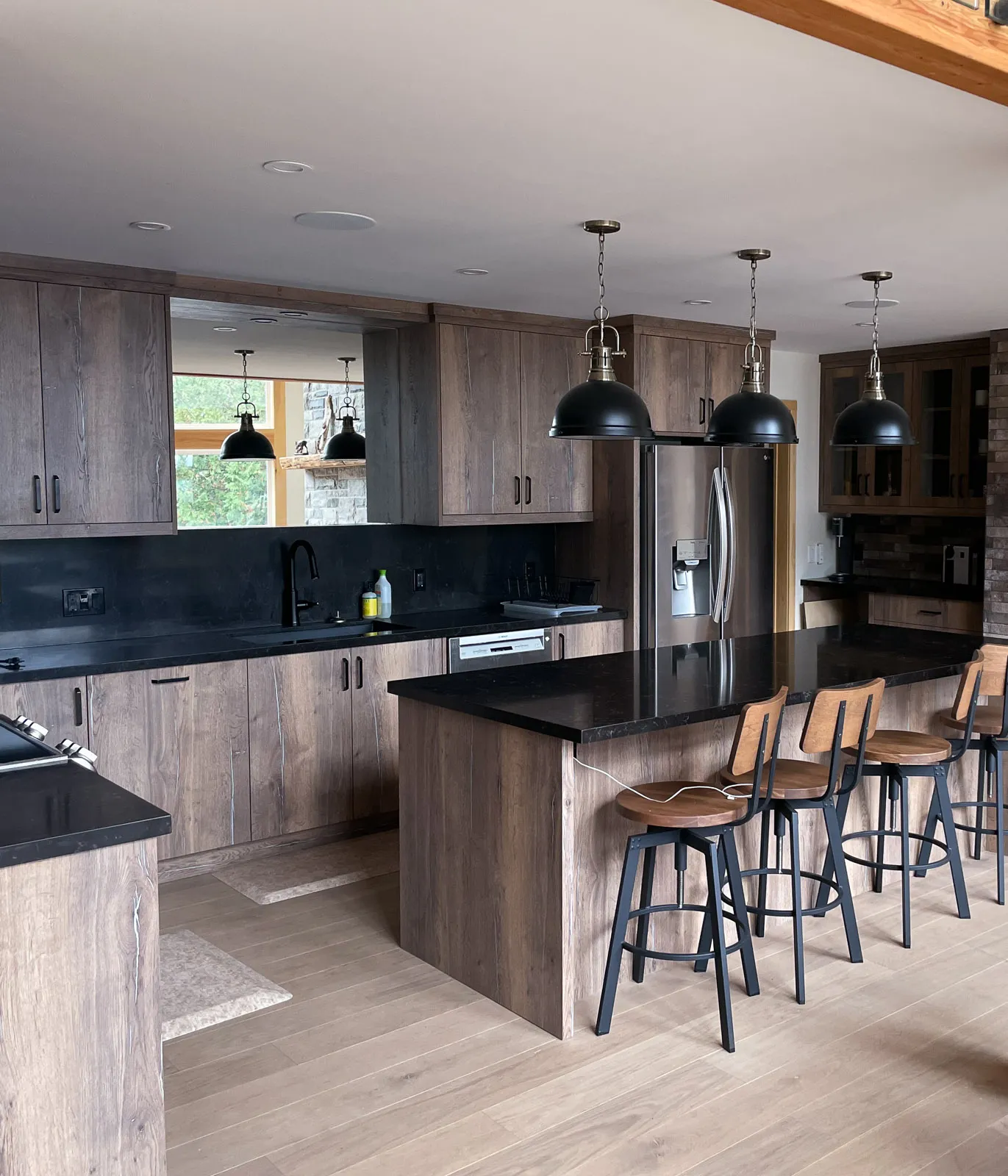 luxury kitchen with black granite countertops and custom built cabinetry.