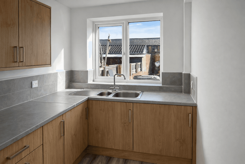 Ground mounted solar panel array installed on steel frame supports in a rural UK setting.