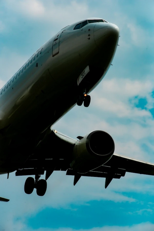 An airplane flies through a circular opening.