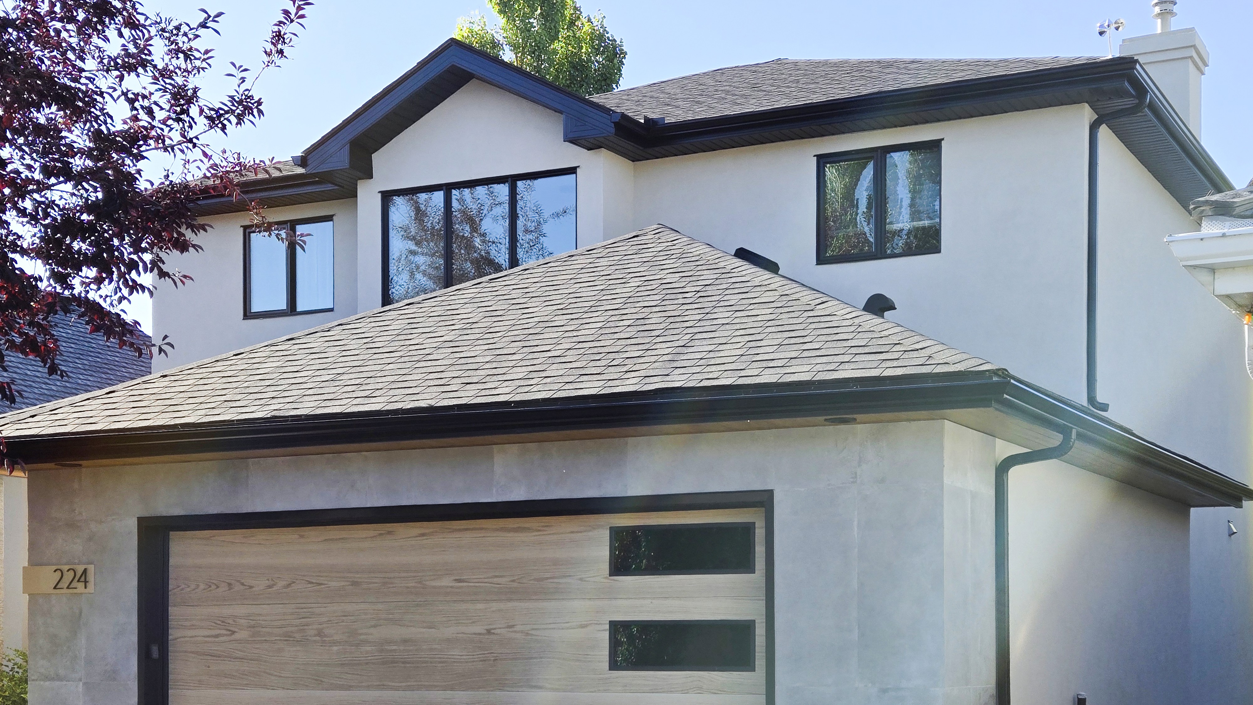 Image of KHD Homes luxury residence exterior with garage and modern design elements.