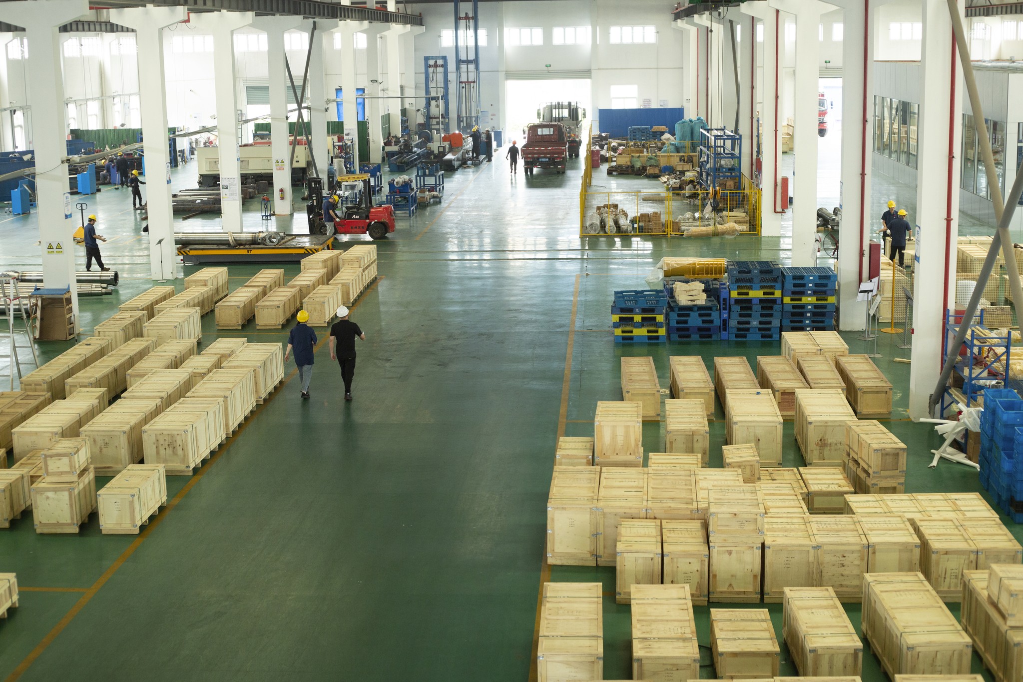 Factory producing aftermarket mining heavy equipment parts, with crates.