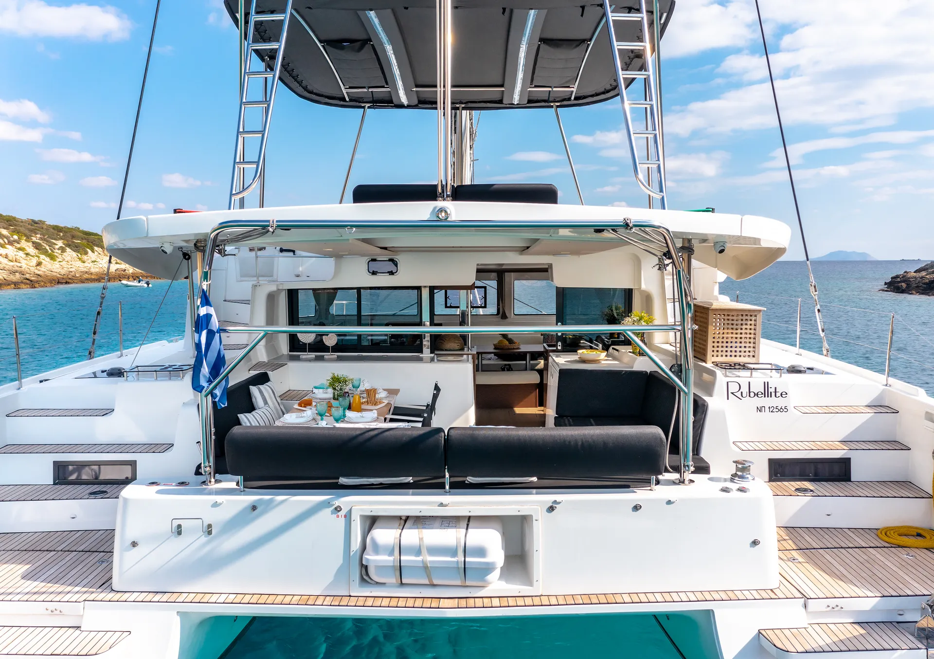 White Rock 36 speedboat with captain at helm cruising calm blue waters near Paros coastline with hills in background.