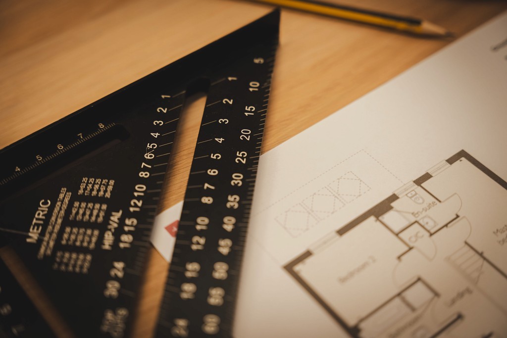 ruler and room plan on wooden table