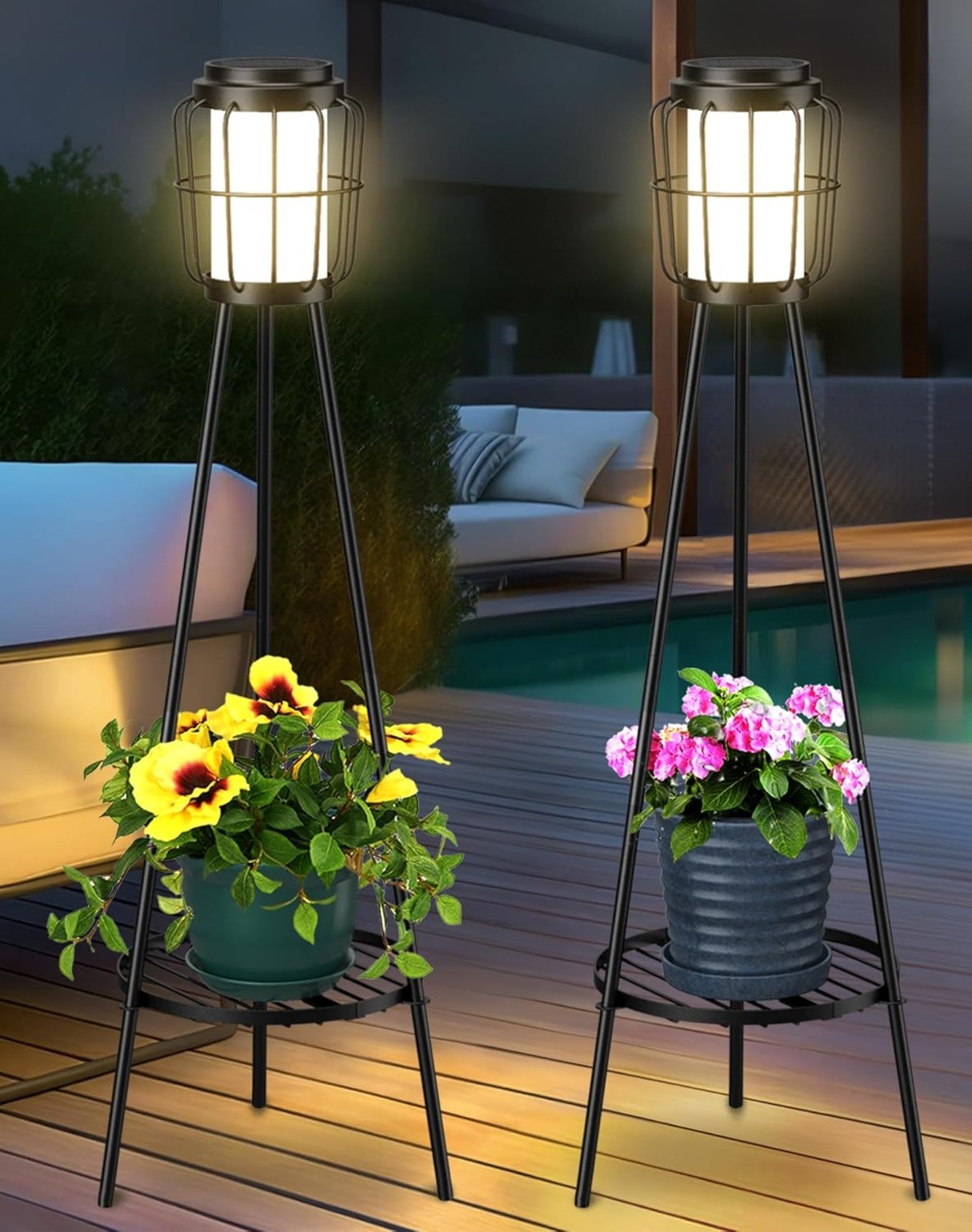 Elegant patio lighting with black metal lanterns on tripod stands, featuring warm LED glow and integrated plant holders for decor.