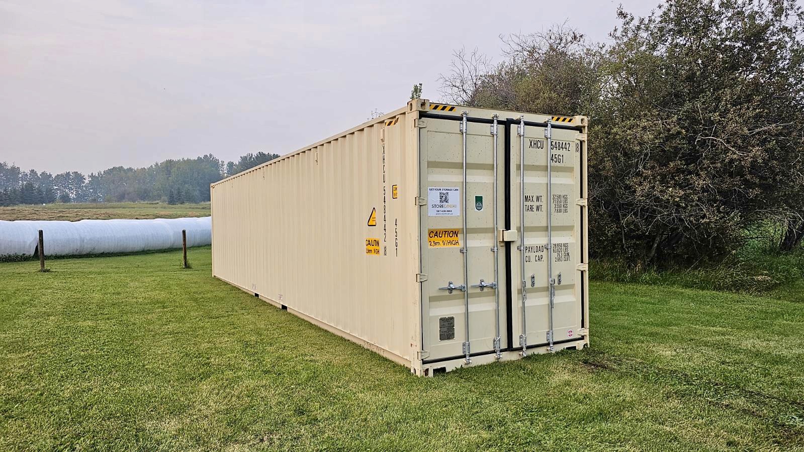 New 40-foot high cube beige shipping container with clean exterior, secure lockbox, and extra interior height for maximum storage capacity.