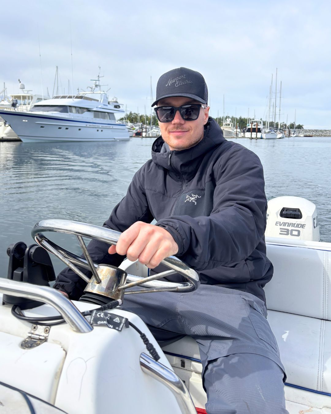Crowley Marine Care Company owner driving a boat on the water and smiling at the camera