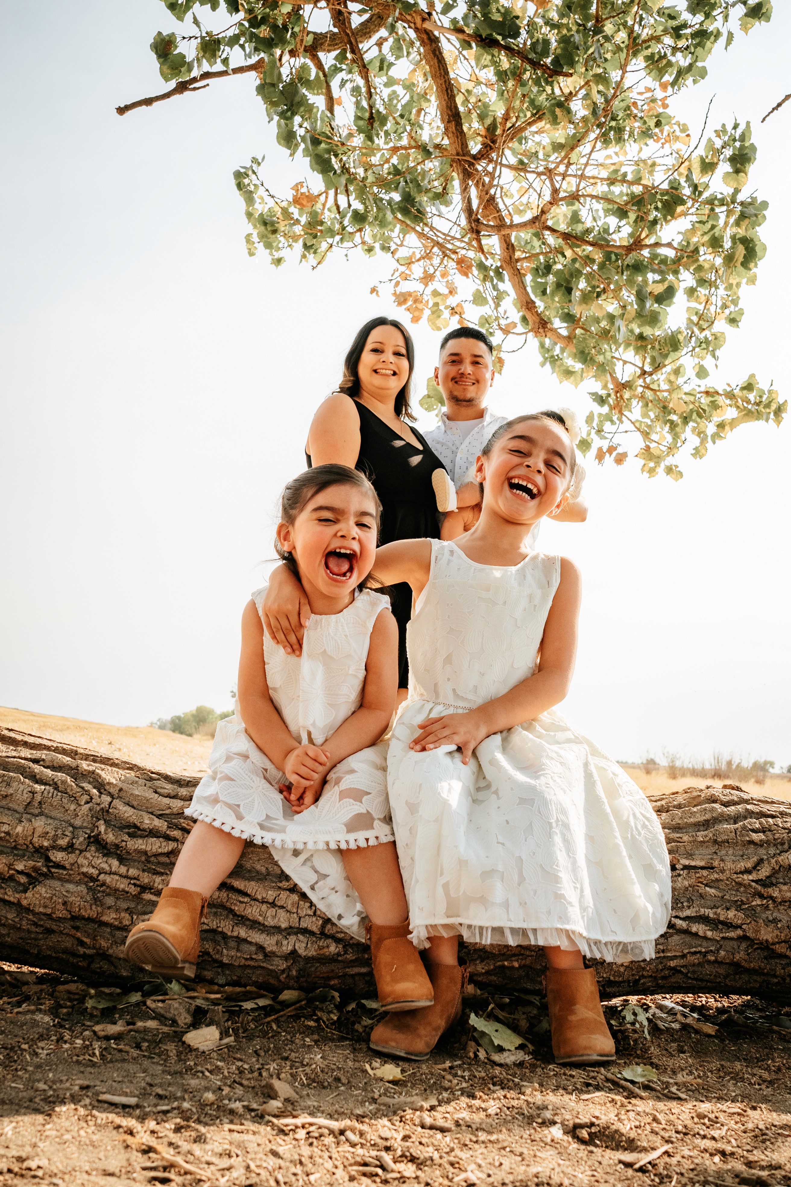 A couple stands closely in an intimate embrace.