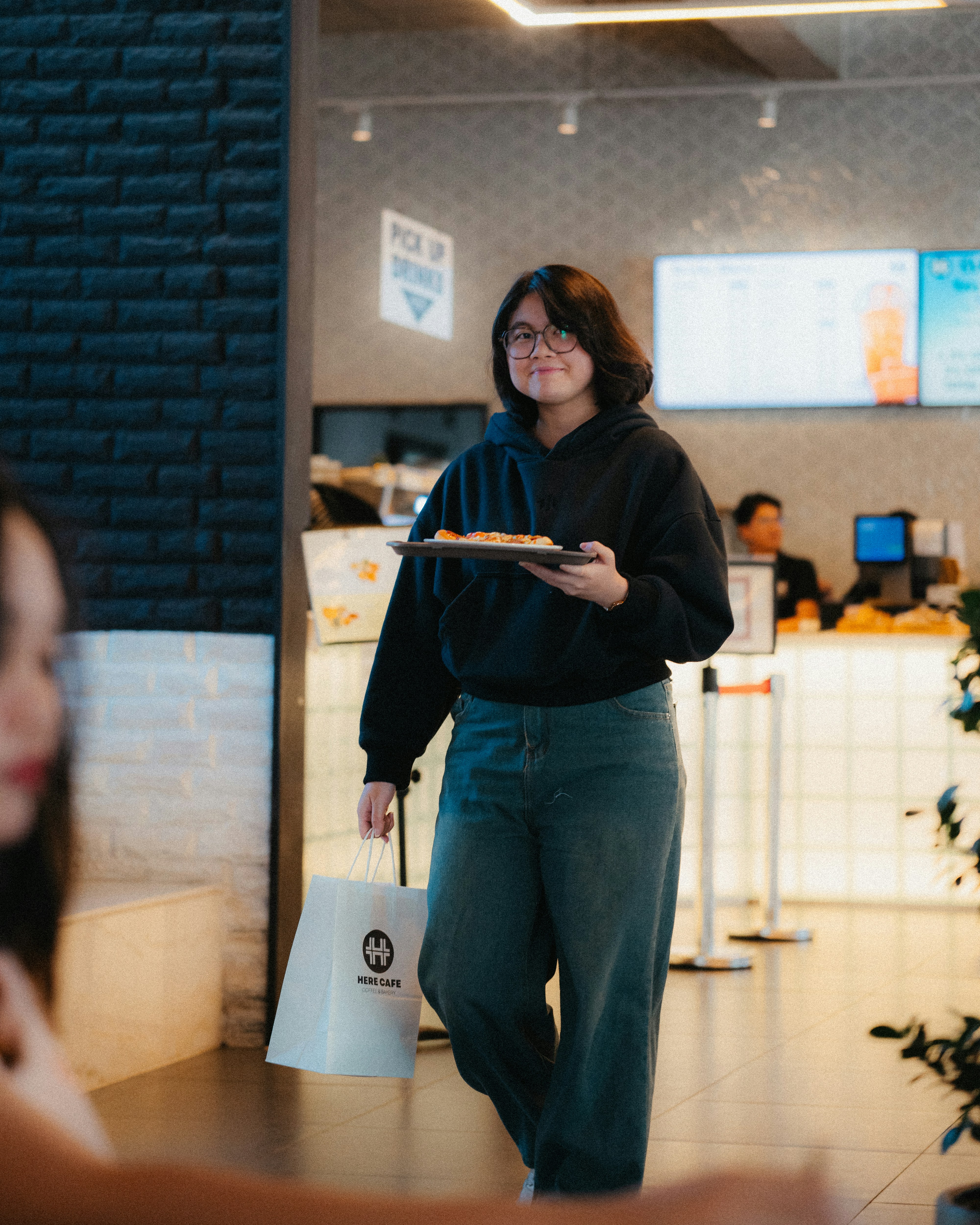 Young woman carrying food in a restaurant