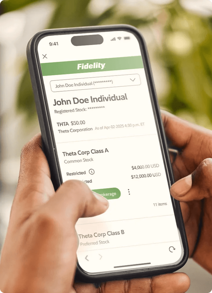 Person holding a phone with the Fidelity.com Stock Transfer application