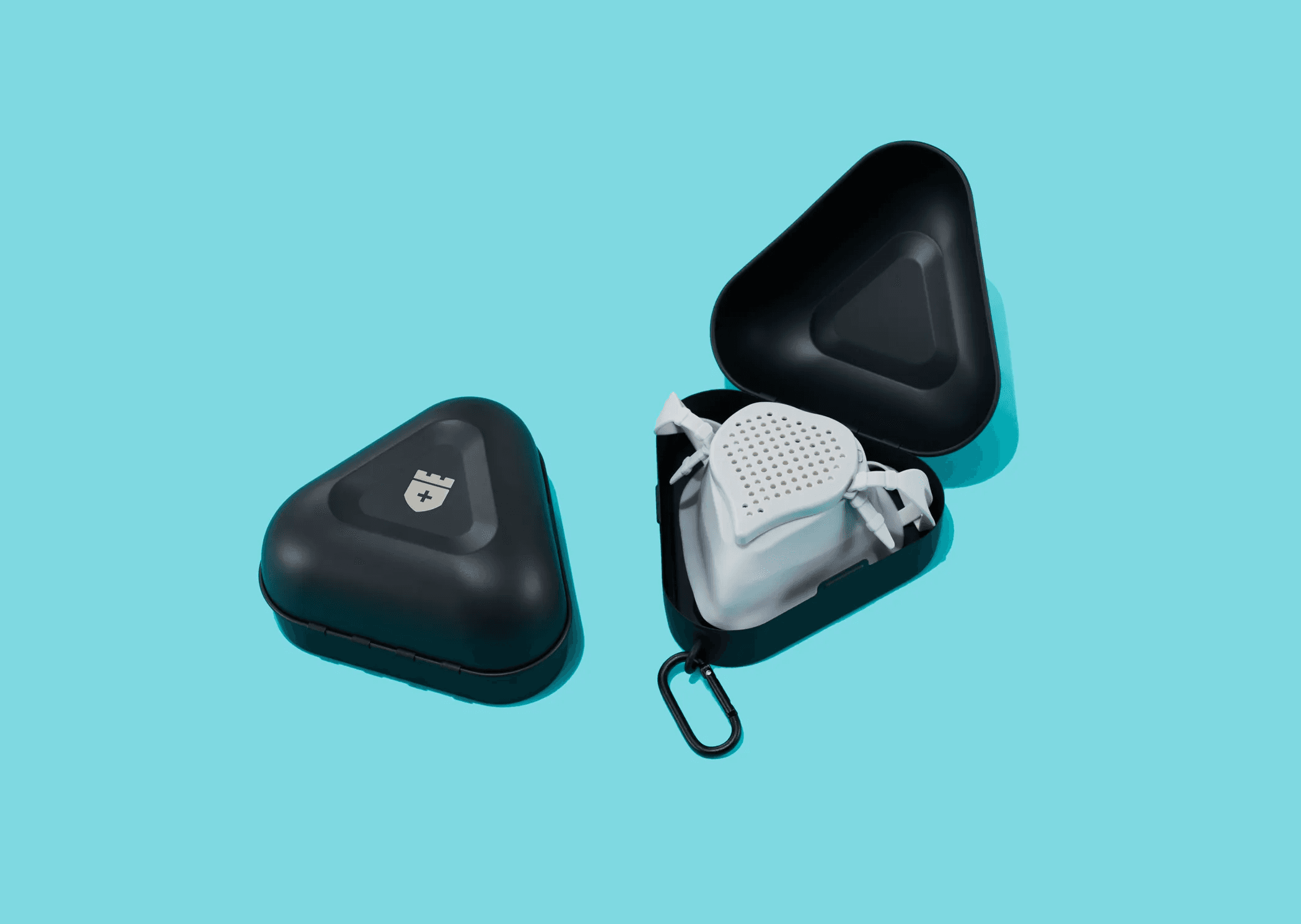 Black and gray CastleGrade PPE cases, with one opened to reveal protective equipment inside