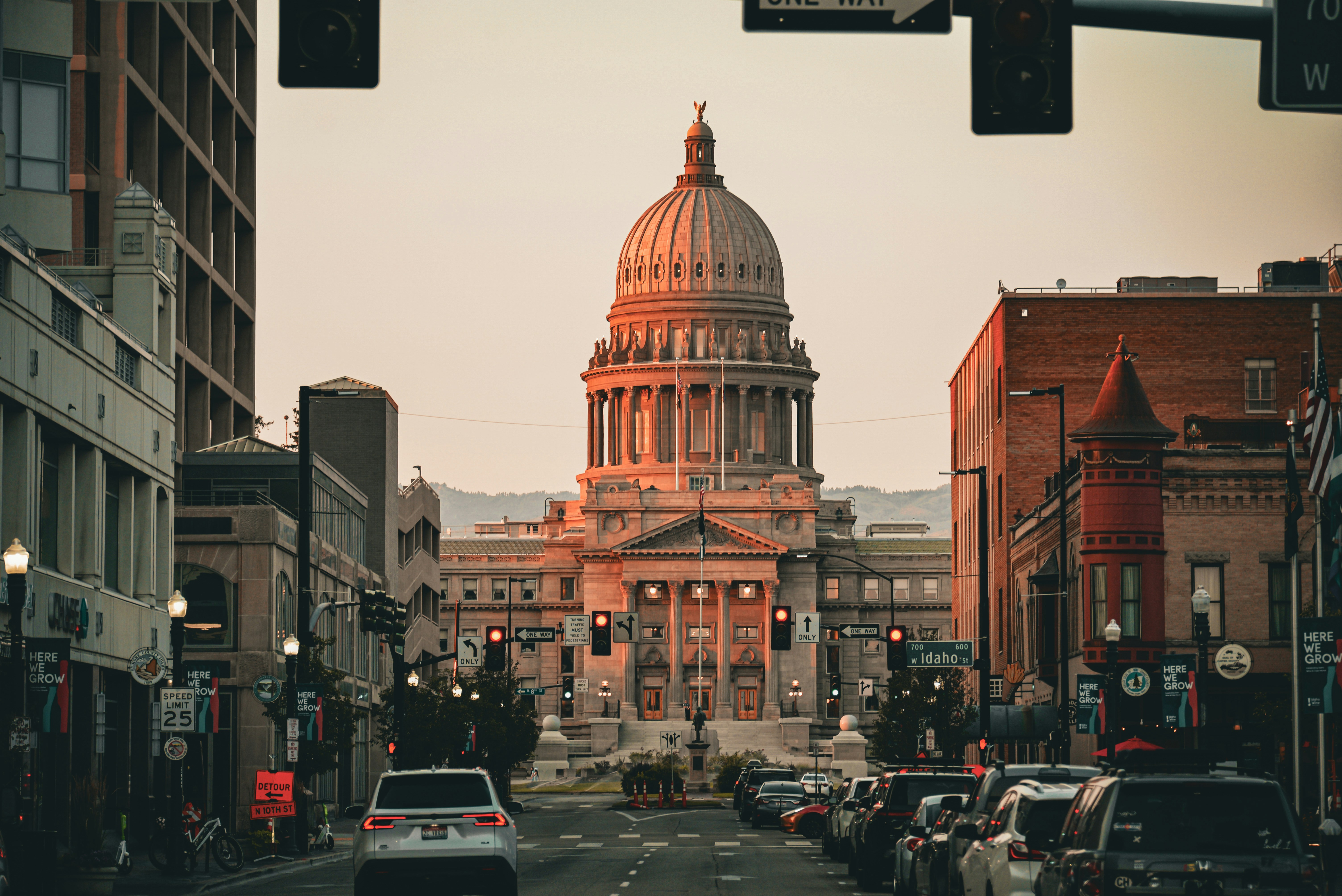 A city street with a large building in the background