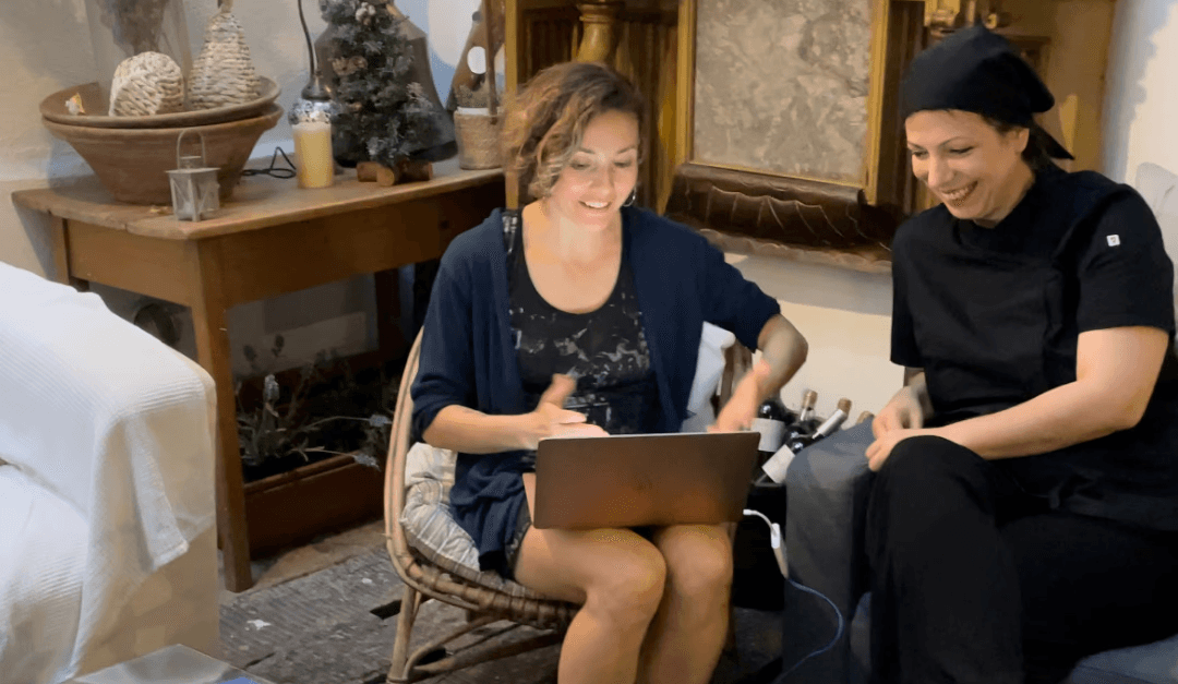 Woman with silver hair and dark makeup.