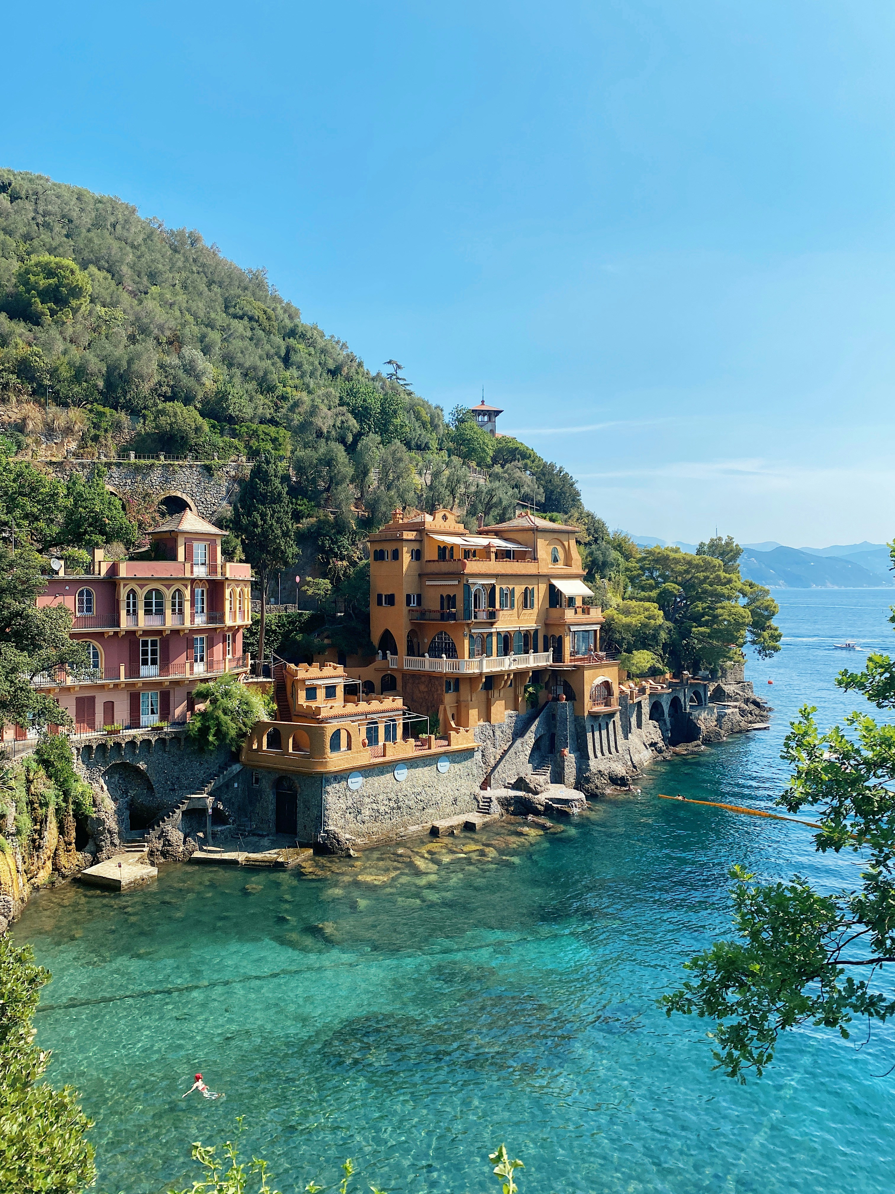 a body of water with buildings and trees around it