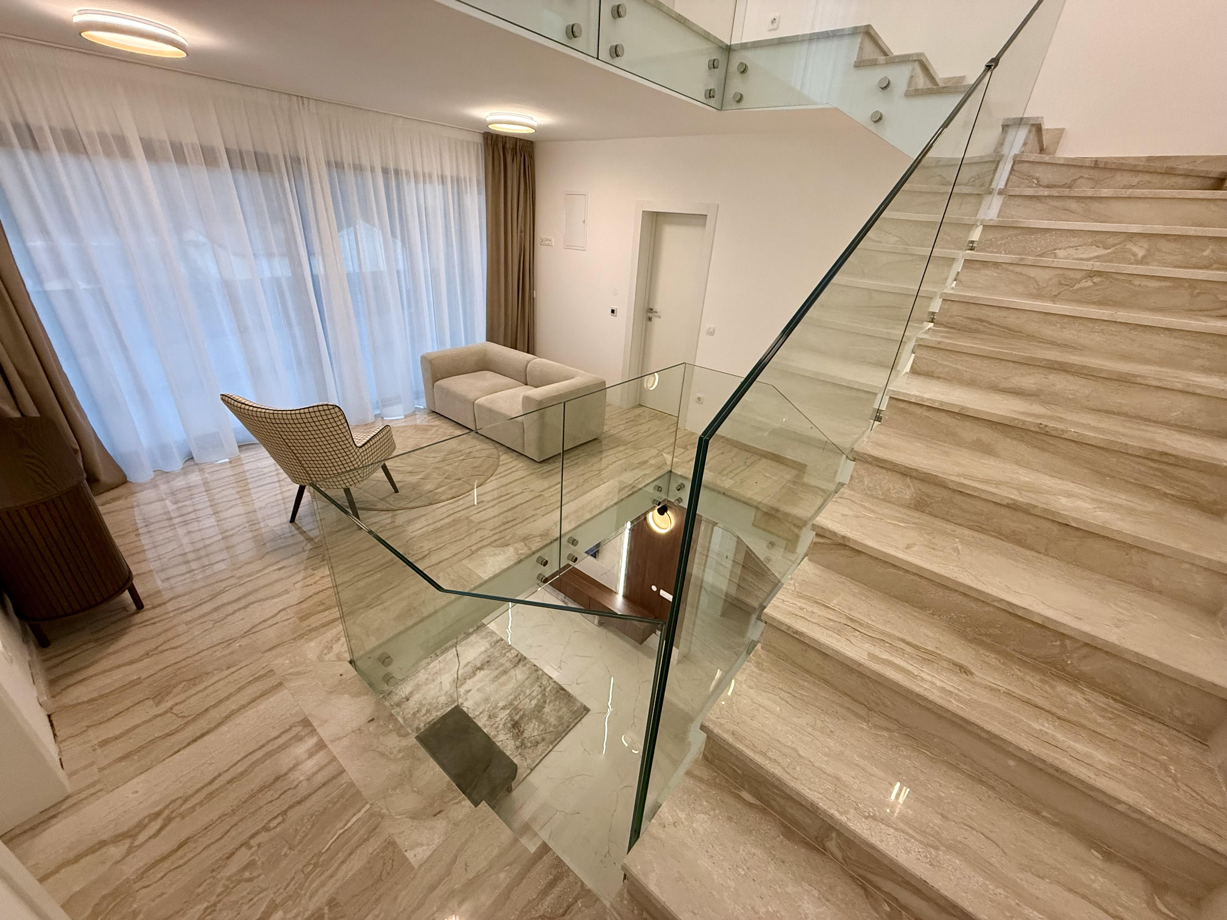 Sleek silver sports car parked next to a modern illuminated pool
