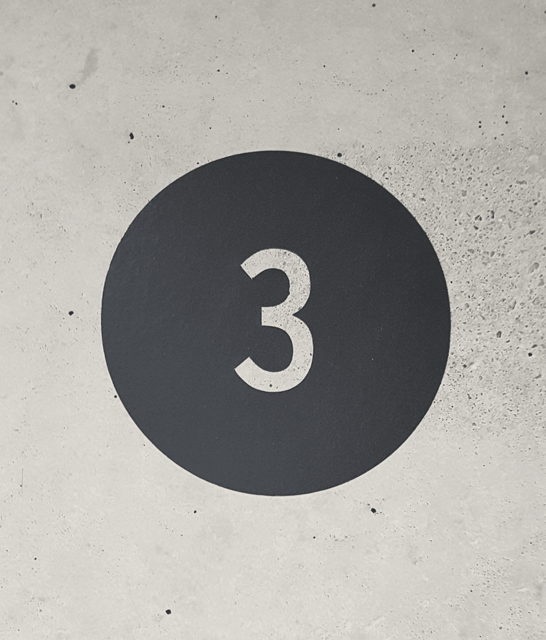 a black and white sign with the number three on it