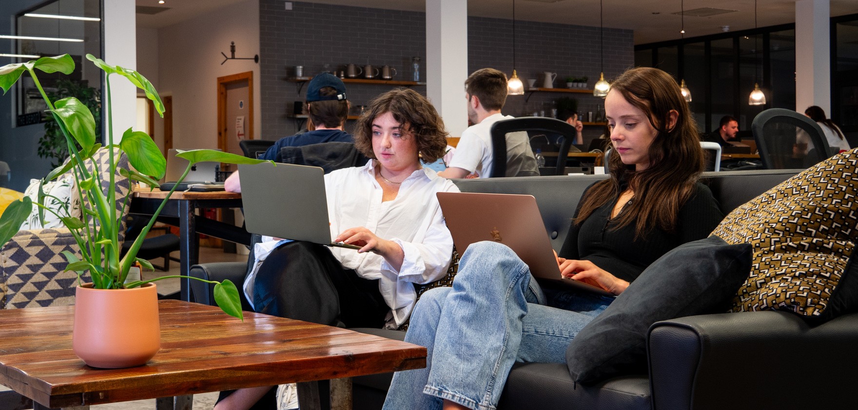 People relaxing on an office break in a bright room.