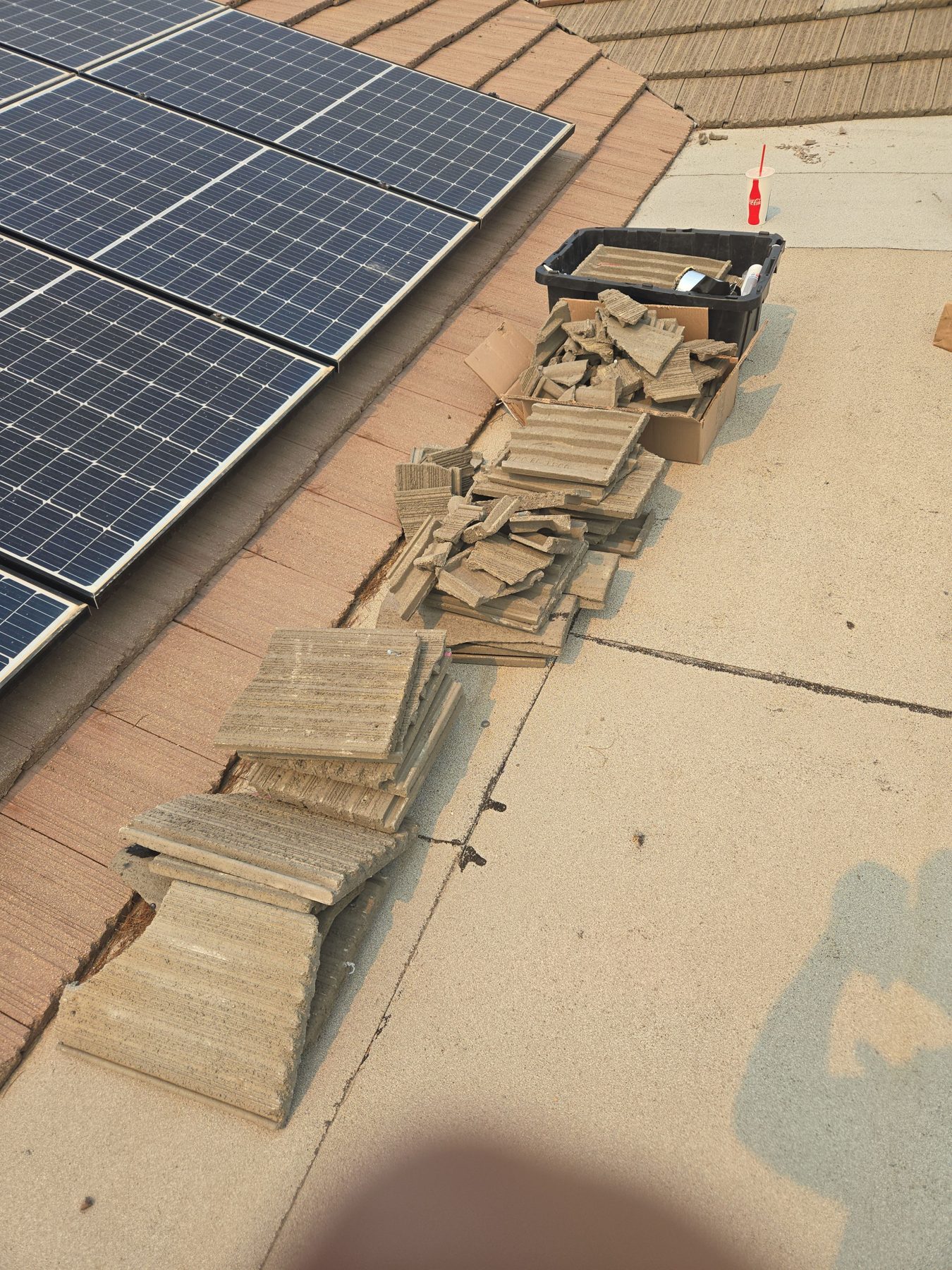 Solar panels removed from a tile roof with mounts exposed for roof work