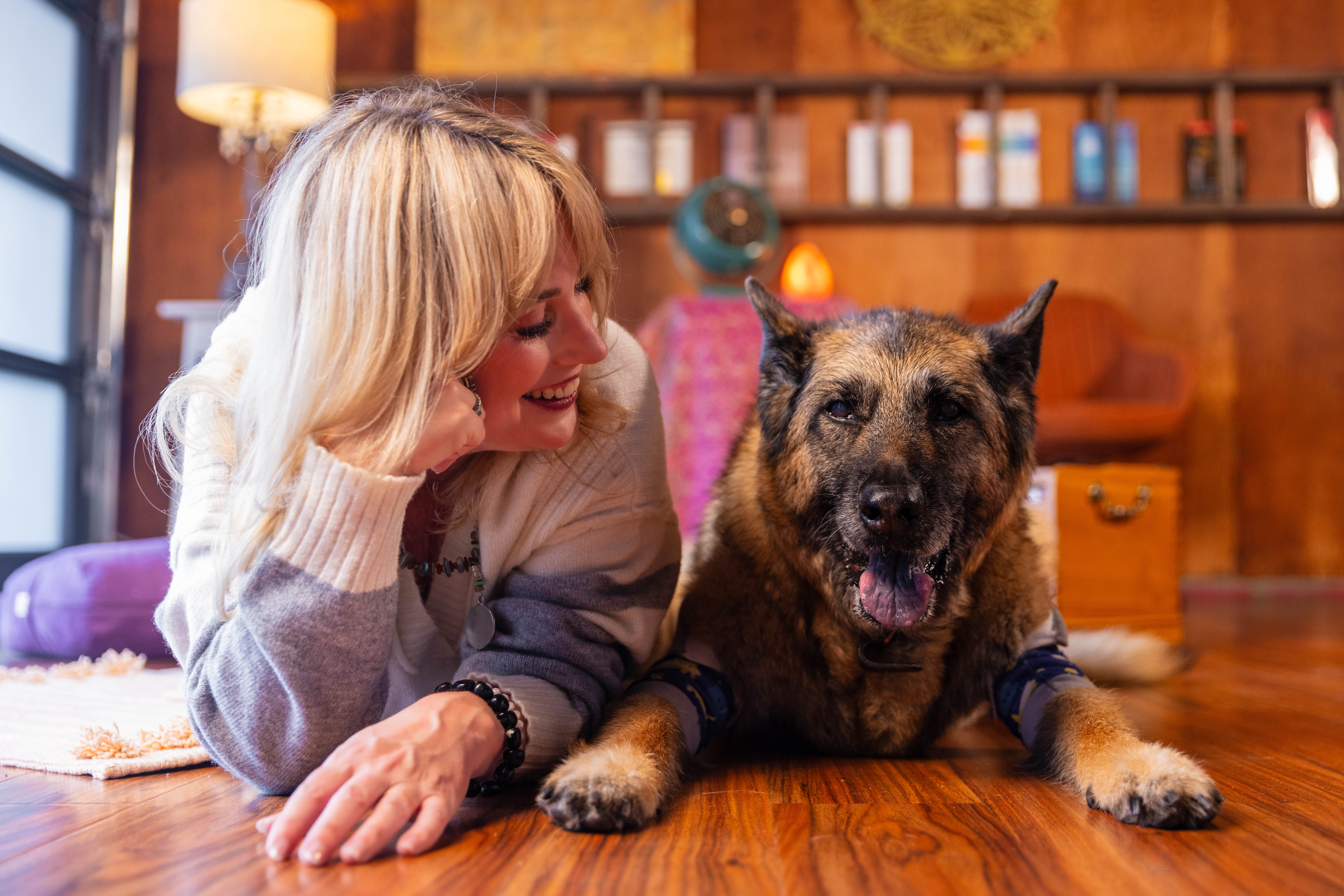 A young woman with wet hair, leaning back in a bath with her eyes closed. The sunlight reflects off the water, creating a serene and tranquil atmosphere.