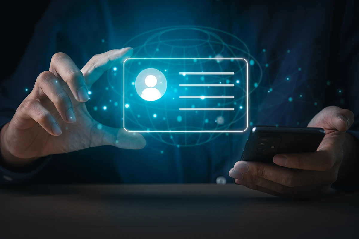 A person walks in front of large stone arches with dark doors, flanked by tall columns, in a historic building.
