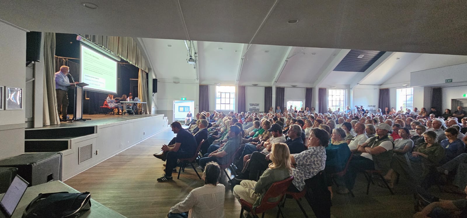 A large crowd attending a public meeting about Fast-track residential development at Arrowtown Athenaeum Hall.