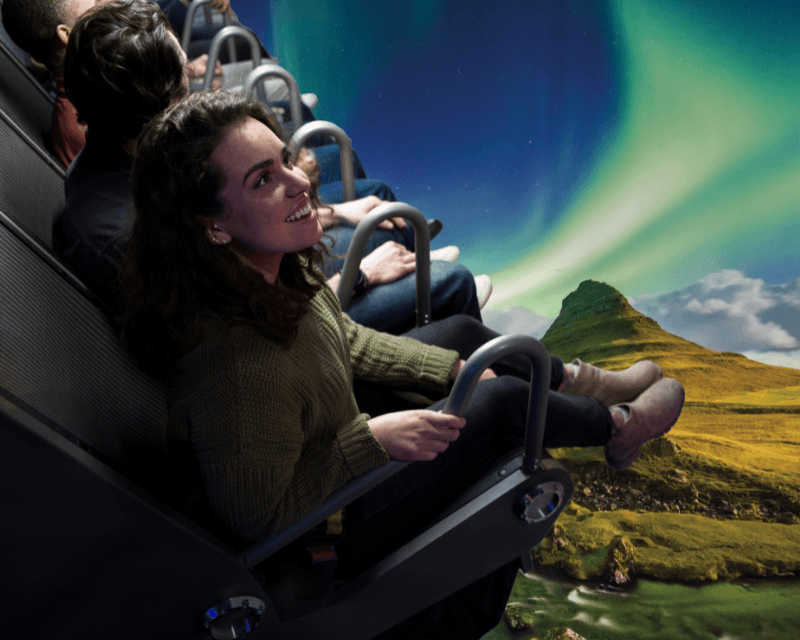 Visitors enjoying FlyOver Iceland ride in Reykjavík, flying over Icelandic landscapes and Northern Lights—an immersive attraction and one of the top things to do in Reykjavik.