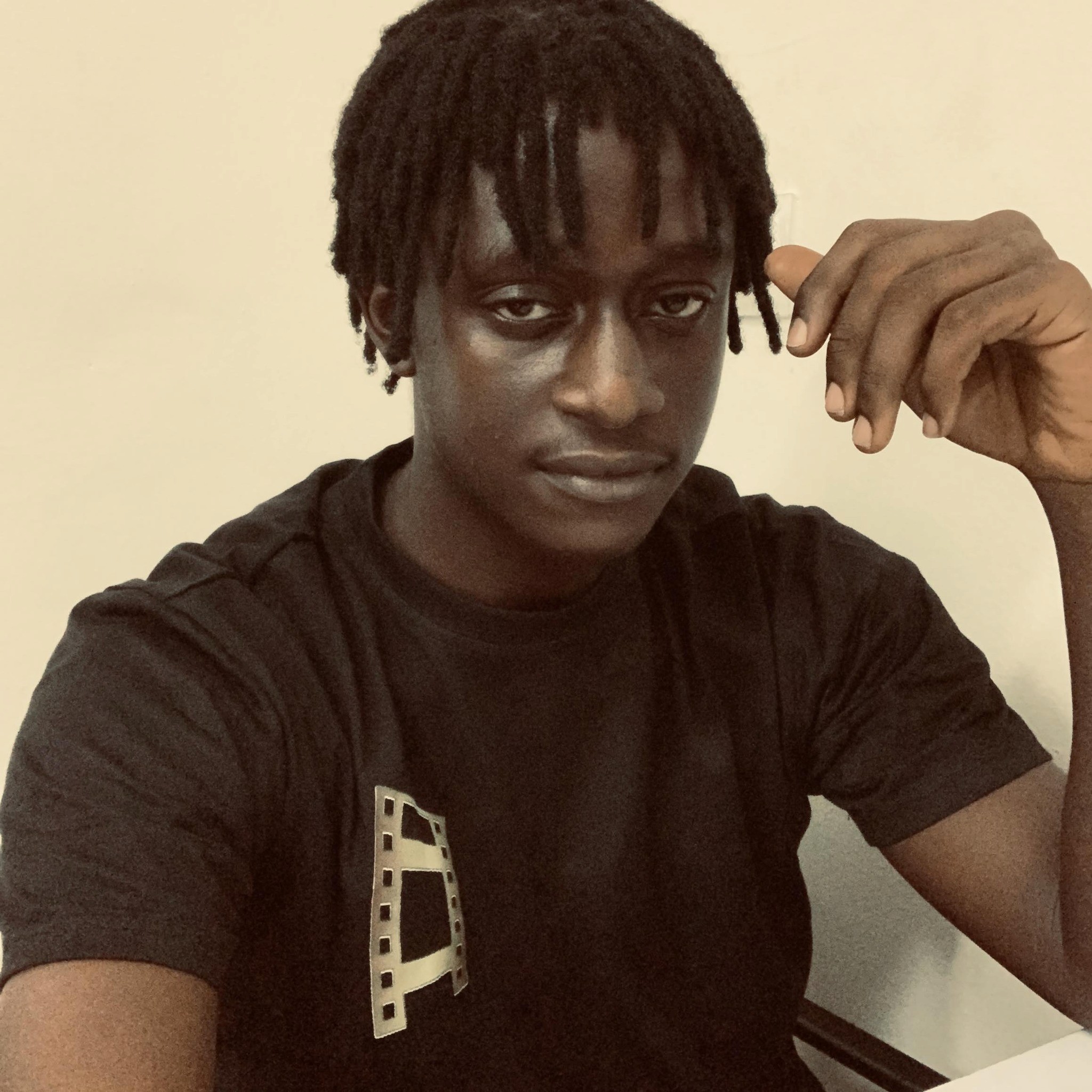 five children smiling while doing peace hand sign