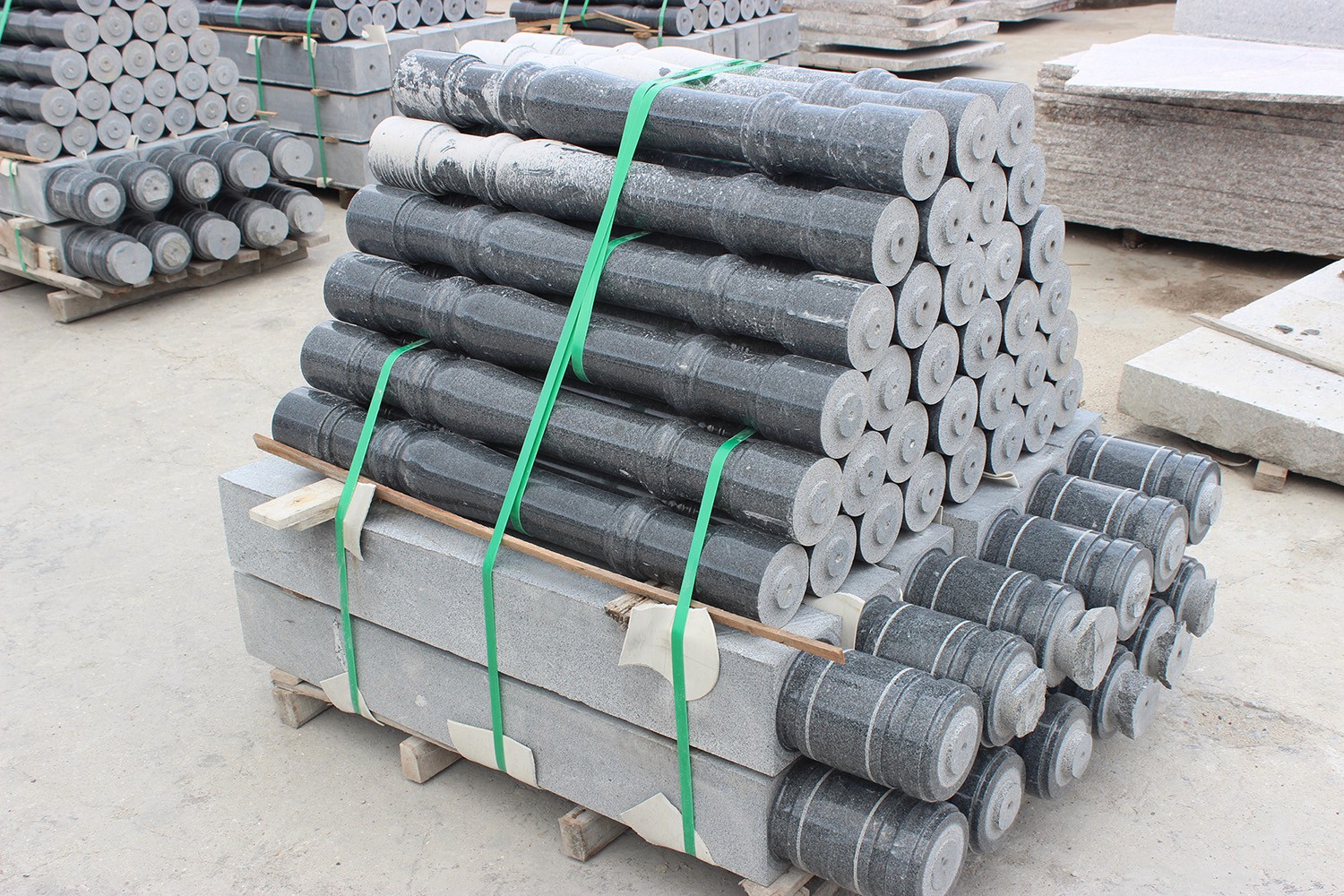 Stack of stone balusters produced by the Vertical 4 Pillars Baluster Cutting Machine, ready for installation in architectural projects, highlighting the machine's efficiency in large-scale production.