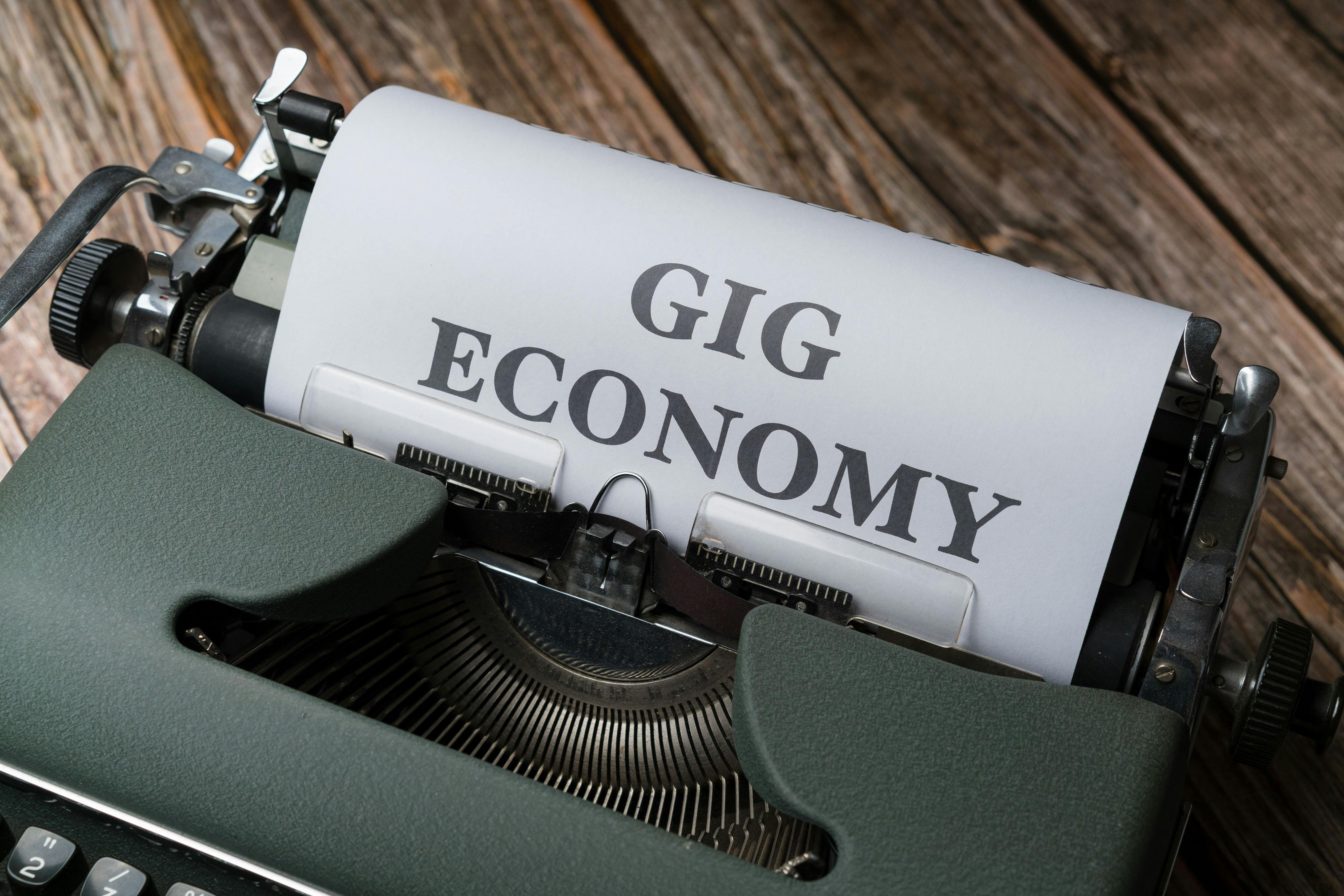 A typewriter with the word gig economy written on it
