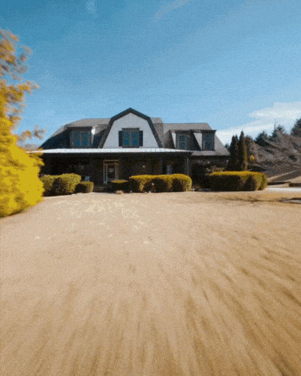 A woman in a straw hat stands in the grass