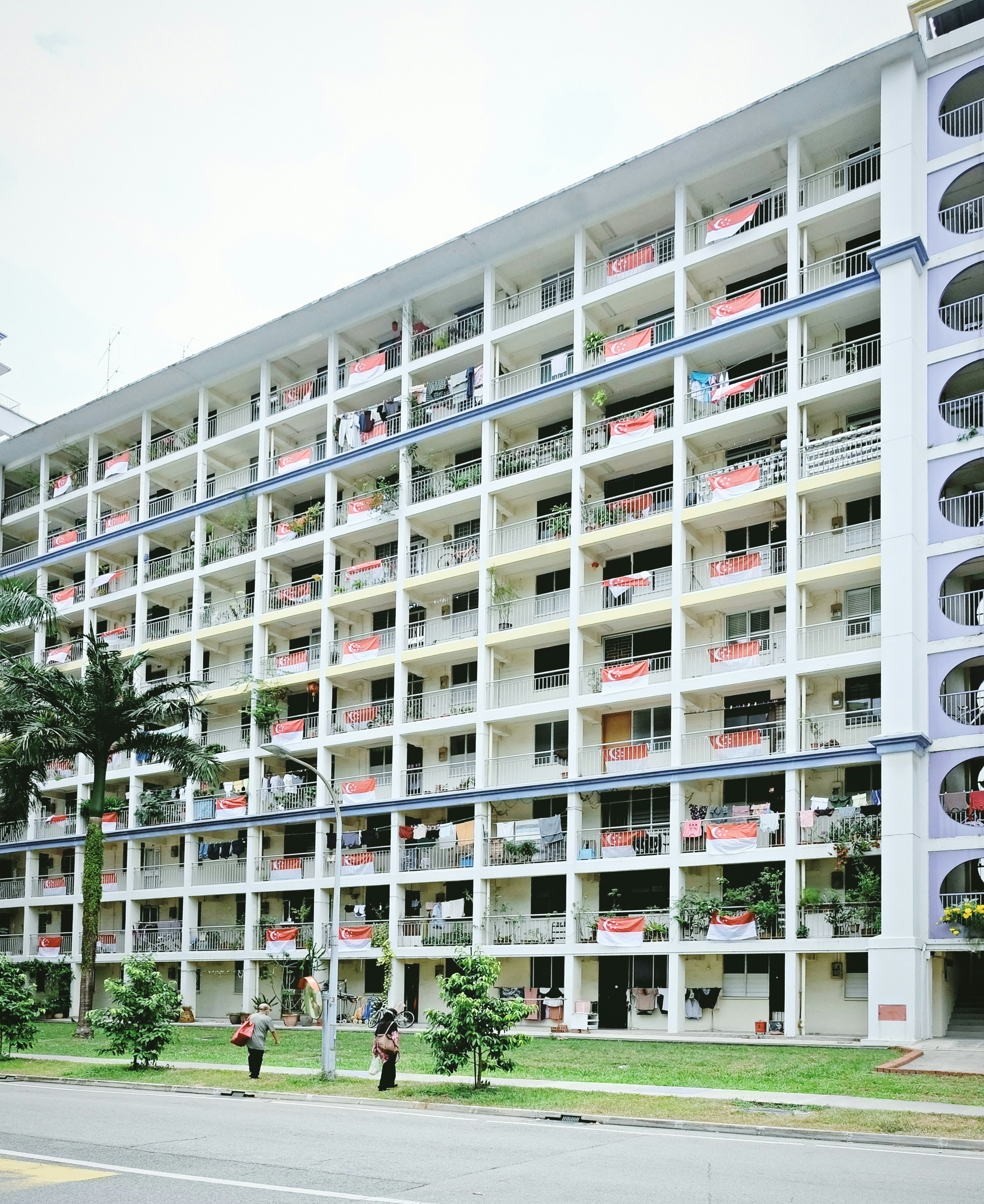 white concrete building near green trees during daytime