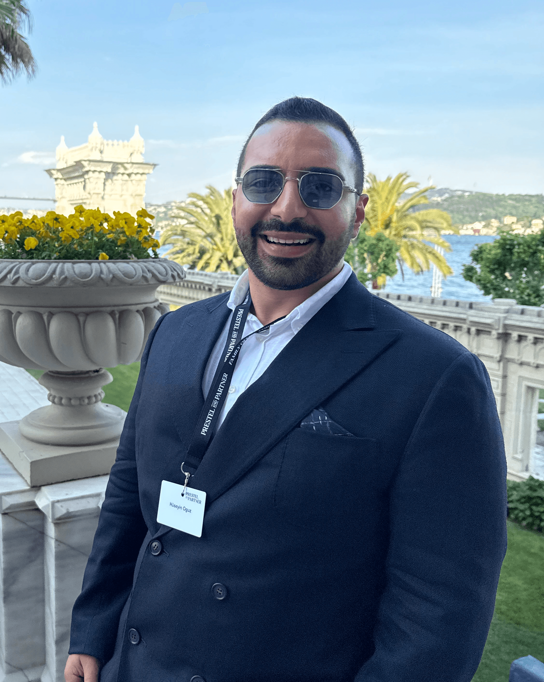 A young person with long, wavy hair sits in front of a plain background, looking directly at the camera.