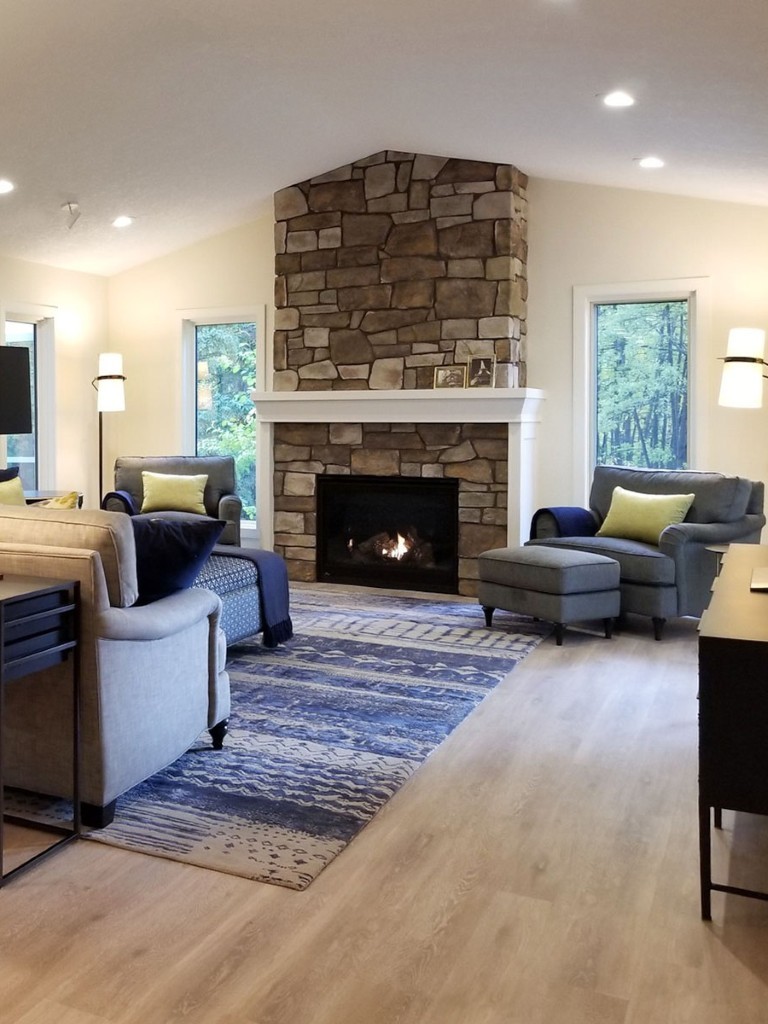 Image of KHD Homes interior design featuring cozy living room with stone fireplace and comfortable furniture layout design.
