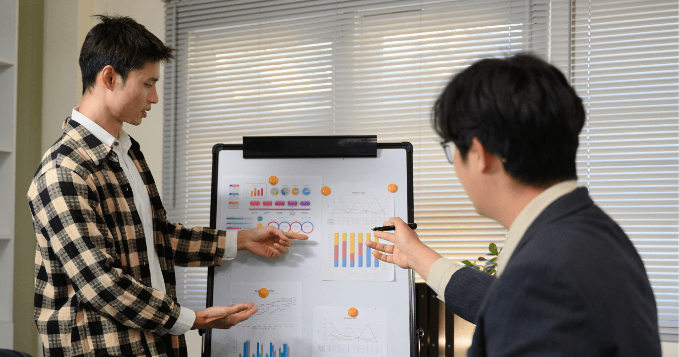 A man and a woman looking at a model of a skeleton