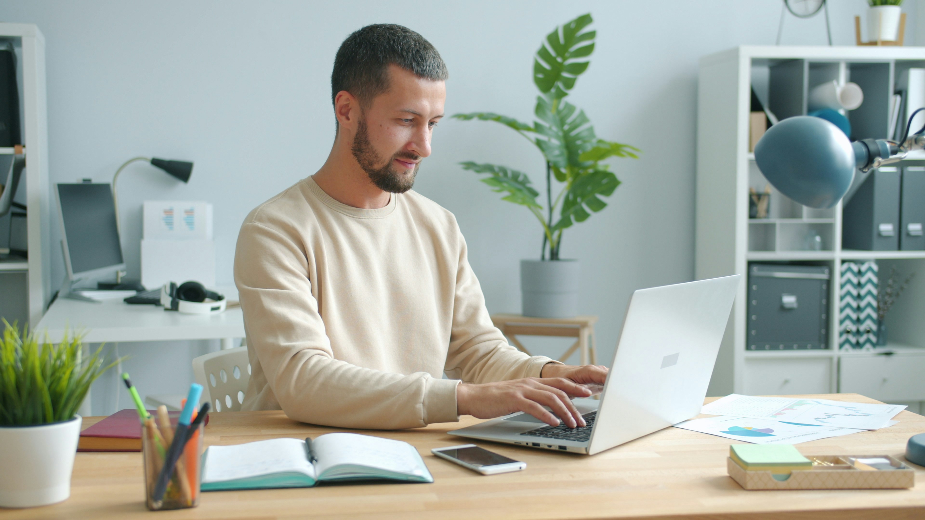 Man typing on laptop at a desk