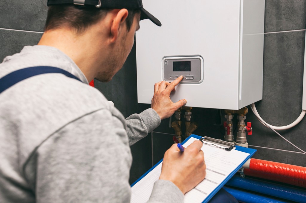 An emergency plumber fixing a leaky pipe in a bathroom 