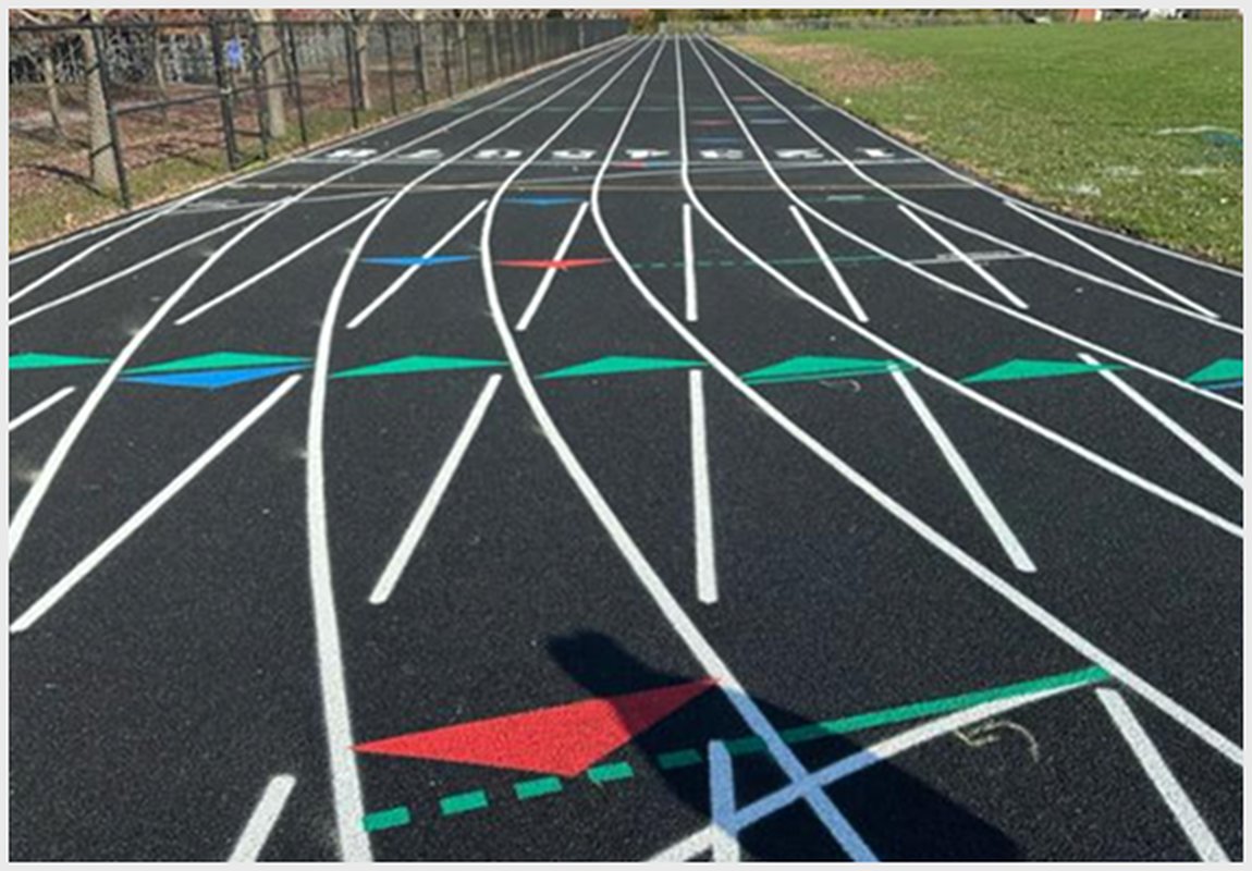 Professional running track construction with curved lanes, detailed line markings, and sprint exchange zones.