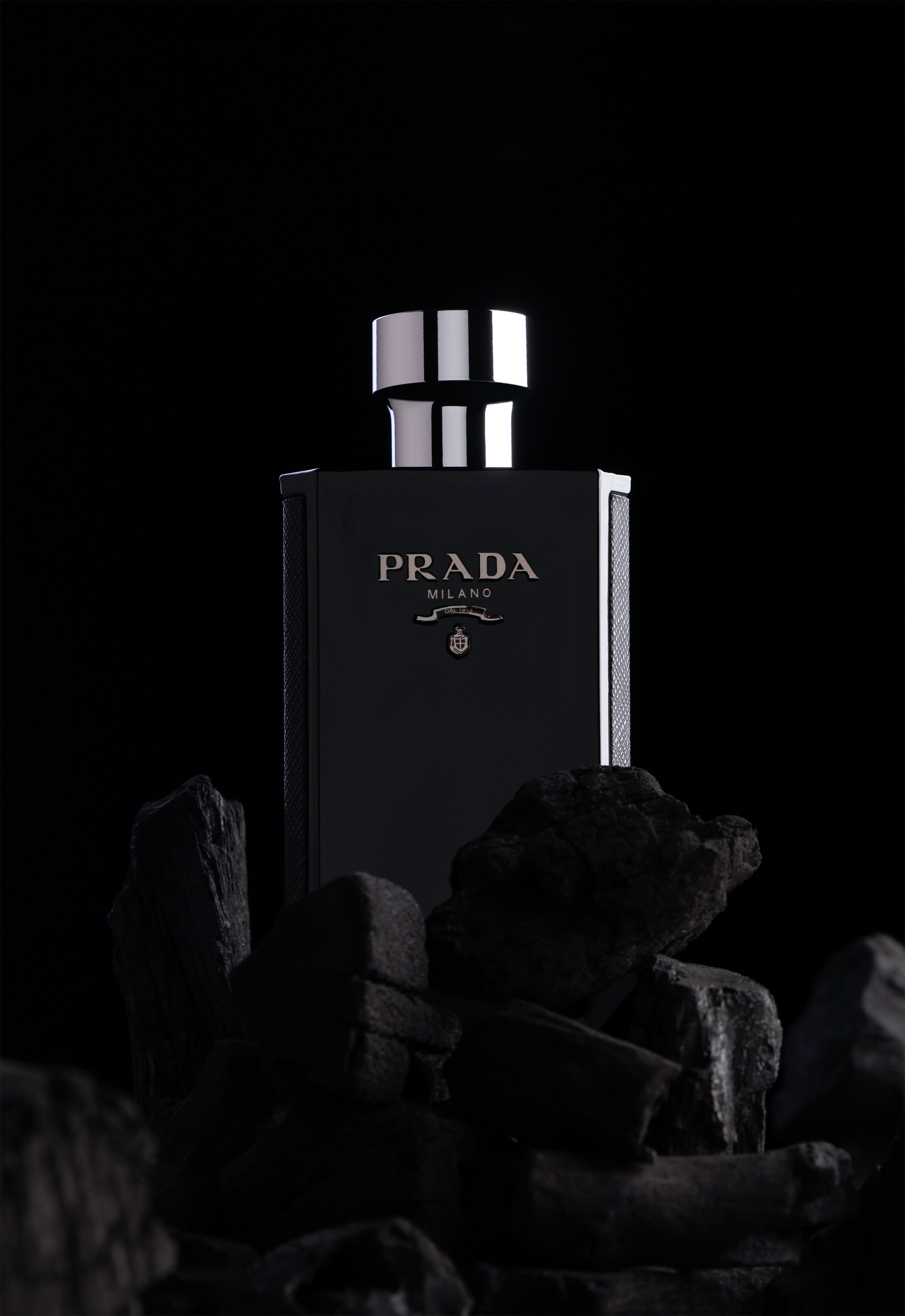 a black and white photo of a bottle of prada