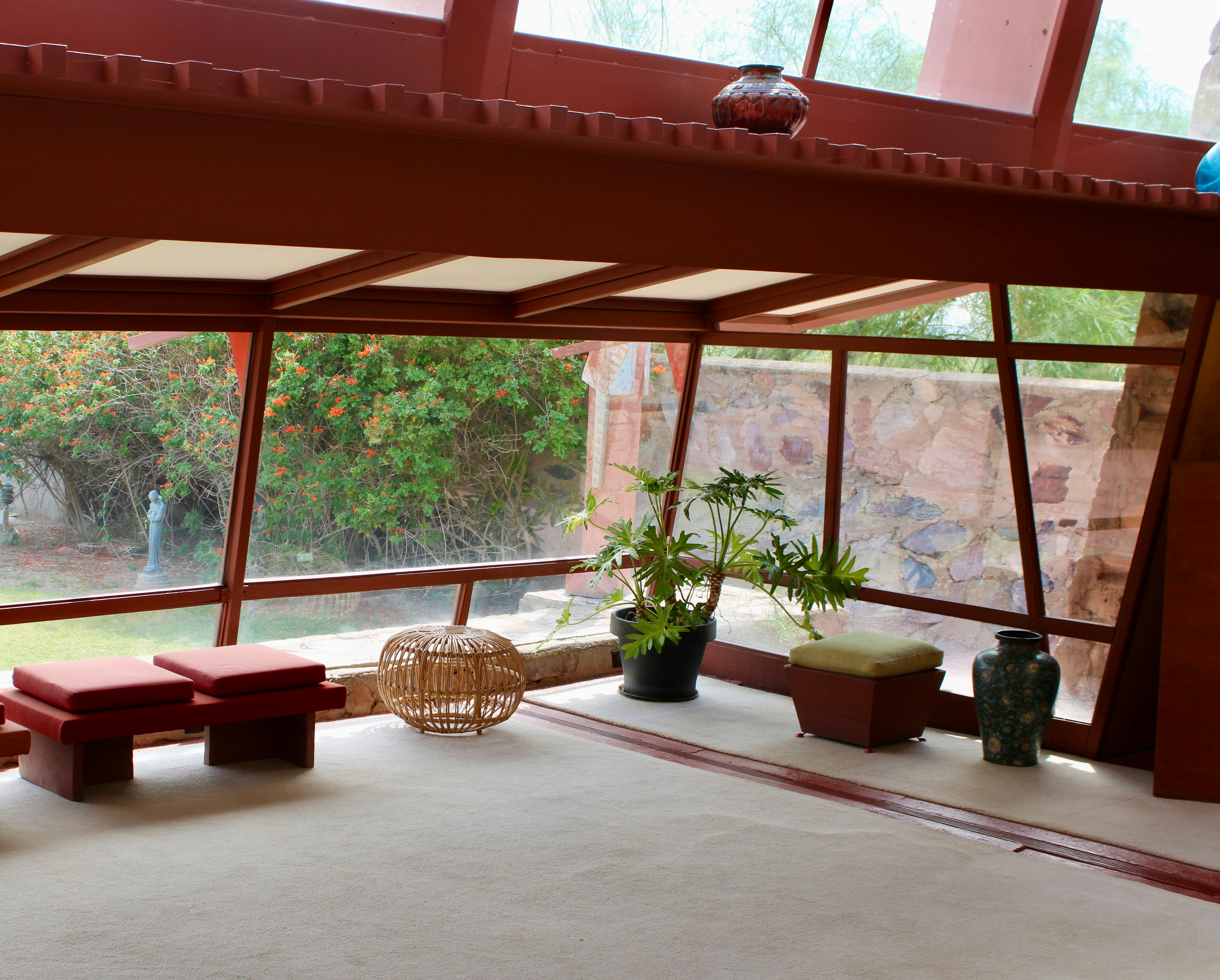 Interior view of a room with seating and plants.