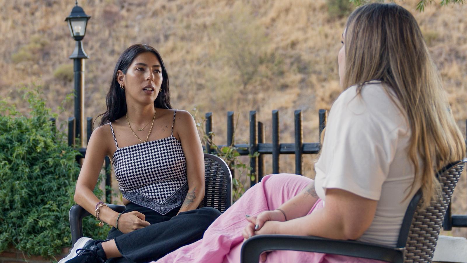 people laughing and talking outside during daytime